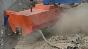 Street sweeping and cleaning machine. A machine for sweeping and cleaning streets using a mechanical brush raises a cloud of dust.