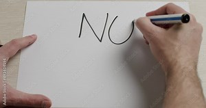 A man's hand writes on Paper message Stop War. Anti-war Movement Activist. We Want No War Message Placard Seen At Military Conflict Crisis Rally. Modern Military Conflict Crisis Issue.