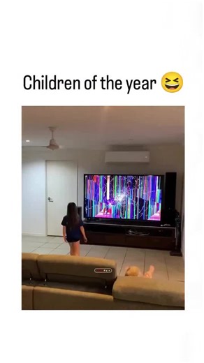 Know in Minutes on Instagram: "The video depicts a mother in a living room frantically tossing her toddler onto a couch after noticing colorful glitches on their large TV screen, implying the child caused the damage, with the caption "Children of the year " poking fun at the chaos. Posted on December 2, 2025, it exploded to 1.9 million views and 57k likes within hours, drawing mixed replies: some criticize the forceful throw as risky child-handling, while others share memes appreciating the over
