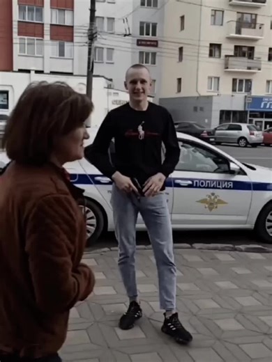 Urban Street Performance in Front of Police Vehicle