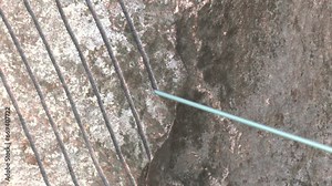 Stone wire saw. Machine for cutting granite stones. Cutting granite in a stonemason's workshop. Single Wire saws. Rubber coated diamond wire cutter. Mostly used for cutting granite and marble blocks