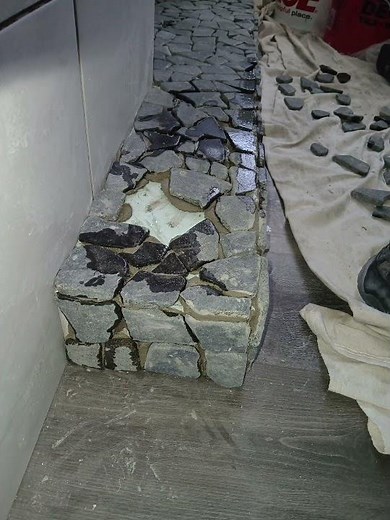 Install pebble stone shower floor wrapped over curb. Derry, NH remodel by Matt Cupan www.TileSNH.com