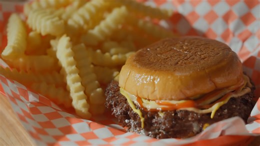 What makes a smash burger fundamentally different from a classic burger