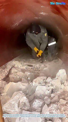 The Delicate Task of Insulation Removal: A Worker's Precision in Action