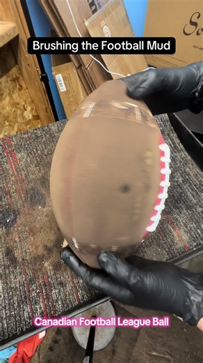 Brushing Mud Off a CFL Football for Better Play