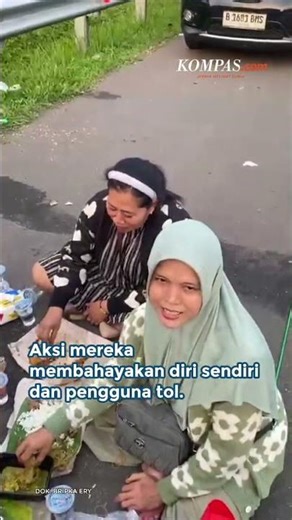 A group of travelers eat together on the shoulder of the Cipali Subang Toll Road.
