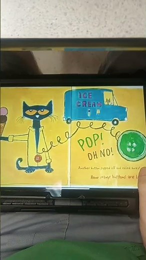 Pete the Cat reads Pete the Cat and his Four Groovy Buttons