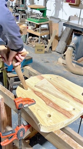 Using A Tapered Wooden Peg To Carefully Test The Fit Of A Mortise Joint In A Round Table Top