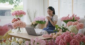 SME owner modern small flower shop work at home office happy smile fist up read text e-mail message banking lending money online. Young adult woman asia people joy seller job in sale order good news.