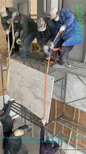 Teamwork: Lifting Large Tiles Onto Scaffolding for Installation