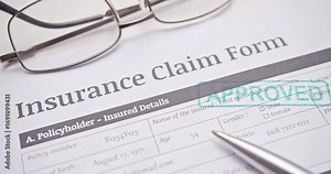 Green "APPROVED" stamp marks an insurance claim form, confirming successful claim processing and official acceptance.