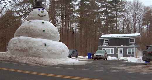 Family builds massive snowman at Massachusetts home
