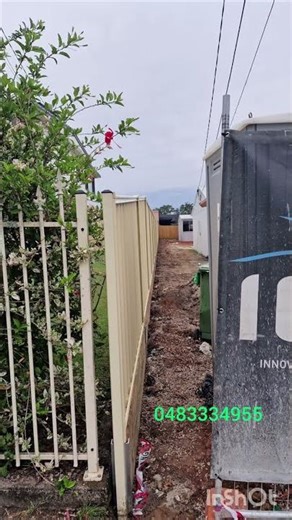 Colorbond fence on top of a timber retaining wall with steel posts in Brisbane.