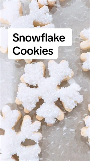 Learn how to make easy cut out snowflake cookies. Decorate them with royal icing or melted white chocolate and sanding sugar. So sparkly and beautiful. INSTRUCTIONS 1. Roll out sugar cookie dough and use snowflake cutters to cut out shapes. 2. Bake until cookies are golden brown along the edges. 3. Allow them to cool fully. 4. Then pipe melted white chocolate or royal icing on top. It doesn’t need to be perfect. 5. Dip this wet side face down into a bowl or sanding sugar until fully covered. 6. 