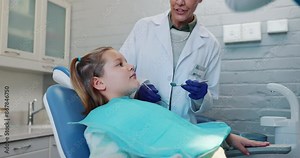 Child, women and dentist in consultation for hygiene examination, dental surgery and oral care with cleaning tools. People, talk and girl for mouth inspection, procedure and tooth extraction service
