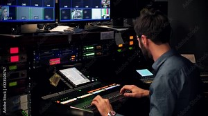 Engineer TV Station Video Production.Studio Director Video Mixer Broadcast TV Station.Operator TV Channel Studio Room.Sound Control And Video Mixer.Man Works In Radio Station Control Room.