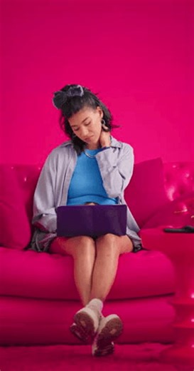 clip-4011118243-studio-girl-laptop-neck-pain-on-sofa