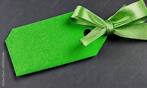 Crafting unique gift tags using vibrant green cardstock and satin ribbons for personalized celebrations