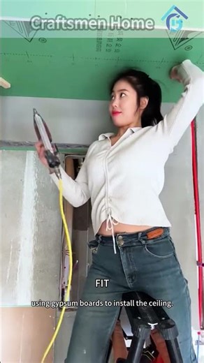 Installing Ceiling with Gypsum Boards on a Ladder