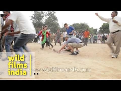 Foreign tourists play traditional Indian game 'Pittu garam'
