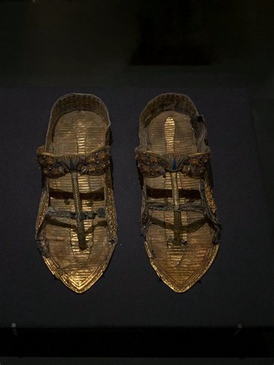 King Tut was buried with 80 pairs of shoes 👑 and researchers believe THIS one may be history's first orthopedic sandal 👇 This golden sandal was made for the pharaoh Tutankhamun — gold, green leather and lapis lazuli, more than 3,300 years old. Look closely at the back: it was built to grip the heel so it wouldn't slip. Why would a king need that? Egypt's own scientists scanned his mummy and found he was born with a club foot and a bone disease in that foot — he was buried with about 130 walkin
