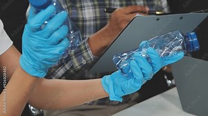 Garbage separation concept. Female hands separate paper and plastic into separate containers in the kitchen at home. Waste segregation, waste sorting, waste recycle.