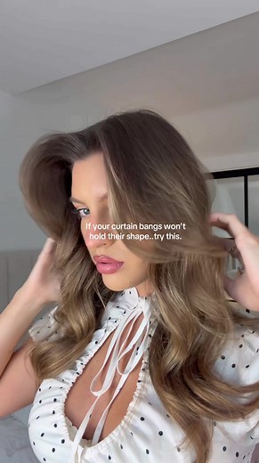 SAVE for the perfect curtain bangs swoop 👱🏼‍♀️ Split bangs in two, blowout and roll front section forwards, back section backwards, set for 5 mins and release 🤍 #stylingbangs #curtainbangs #hairhacks