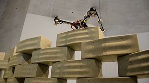 A group of flying robots construct a 20-foot-tower, from beginning to end