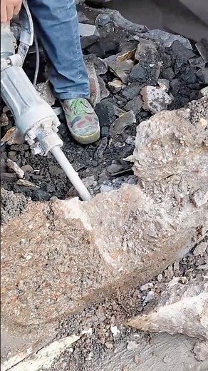 Breaking concrete surface using electric jackhammer tool