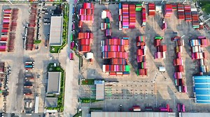 The yard is organized into different areas, including storage areas for loaded and empty containers, areas for container maintenance and repair, and areas for truck and rail loading and unloading.