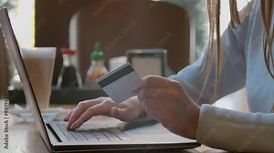 Young woman paying bill, shopping online, inserting credit card number. Attractive woman paying for online shopping using laptop and credit card. close up.