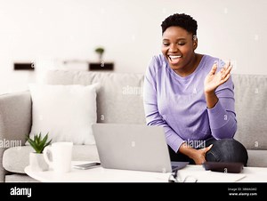 Black woman having video call using computer and gesturing Stock Photo - Alamy