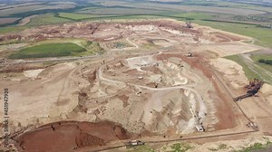 Drone flying over open pit mine, quarry. Open pit for gold mining. Aerial of of opencast mining quarry. Giant quarry with minerals extraction. Large industrial sand quarry.
