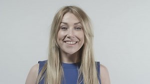 Young blonde woman talking to camera