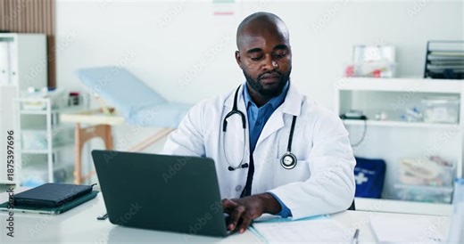 Black man, doctor and reading with laptop in office for research, medical report and patient history. Person, pc and document for Telehealth, healthcare records and information for treatment planning