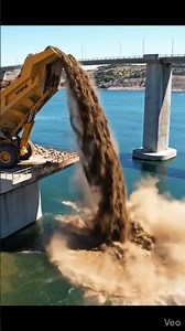 Dump truck unload soil into the river