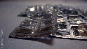 Empty pills from blister packs on the table, Used pill blisters, Danger of overdose, Drug abuse. Concept of medicine, health care and pharmaceutical industry.