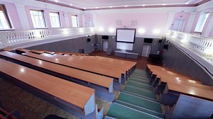 Tables and chairs in classroom. Modern wooden lesson in conference room
