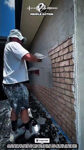 Construction People Applying Wall Plaster Over Brick Surface During Exterior Finishing Action