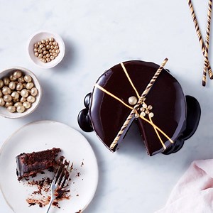 In need of cake-spiration? Our new Belgian chocolate mirror glaze cake is the ultimate showstopper: three layers of chocolate sponge and hazelnut-feuilletine, glazed with a mirror shine and decorated by hand. Now time for us to cut a slice and enjoy the final of GBBO. Good luck to all the finalists! 😍 | Marks and Spencer
