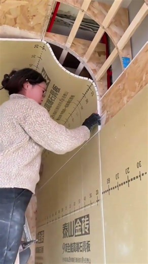 flexible gypsum board installation on a curved wooden ceiling frame