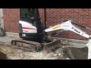 Bobcat e26 digging a test pit