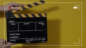 Download Clapper board. Close up hand and film making clapperboard isolated on background for free