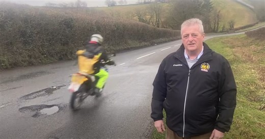 Motorcyclist inches from pothole disaster
