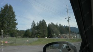 Road Trip Hwy12 driving fast and slow, exits, businesses homes fields animals signs light shadows two-lane paved road overcast day.