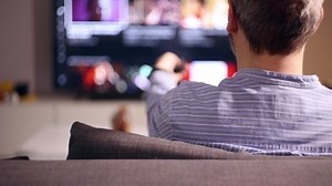 clip-1064636119-person-watching-tv-home