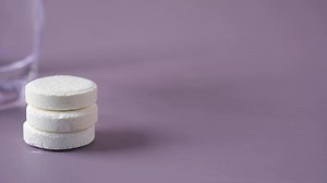 Download Effervescent tablets on table next to glass for free