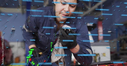 Female tech plugging cable on engine bay in auto shop, activating AR graph and reading diagnostics