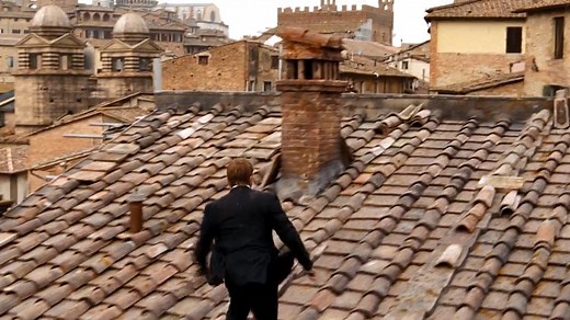 Bond chases Quantum mole Mitchell (Glenn Foster) across the rooftops of Siena in QUANTUM OF SOLACE during the Palio race. The sequence took two weeks to capture and used the largest GoCam system (cameras hanging from wires that can be moved in any direction) ever deployed for a film. | James Bond 007