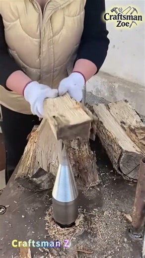 A female farmer splits wood with a fixed conical chopping board